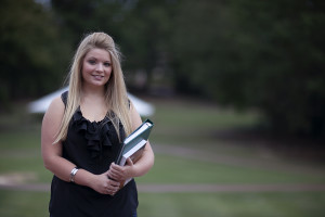 NC State student holding books on campus