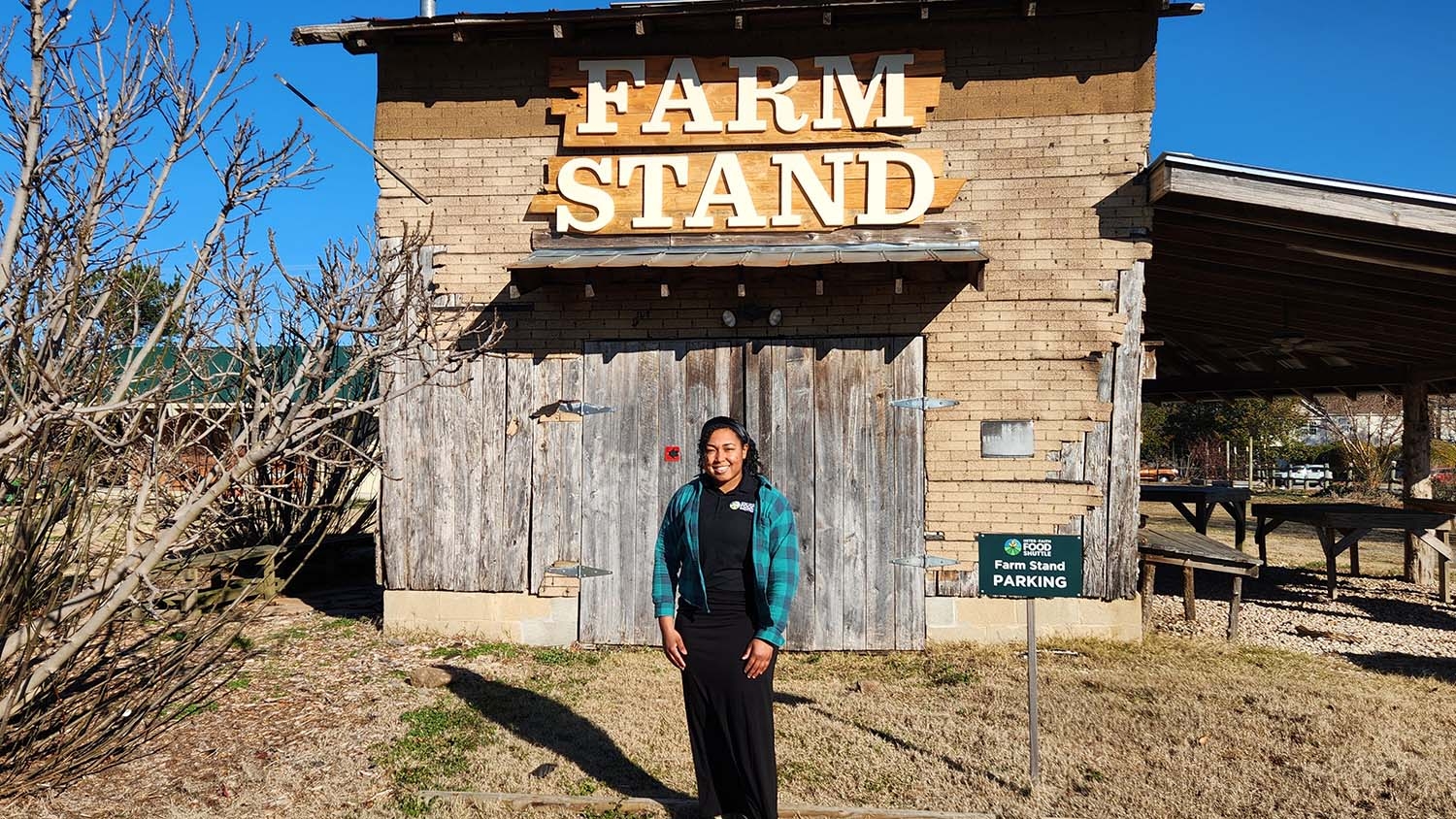 Young woman standing in front of a market building