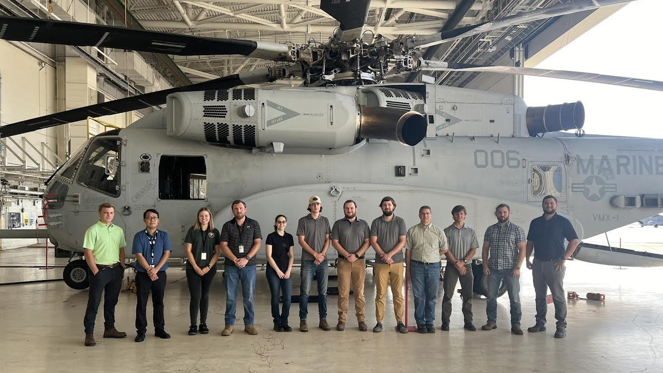 Savannah Tabor and classmates in front of a military plane.