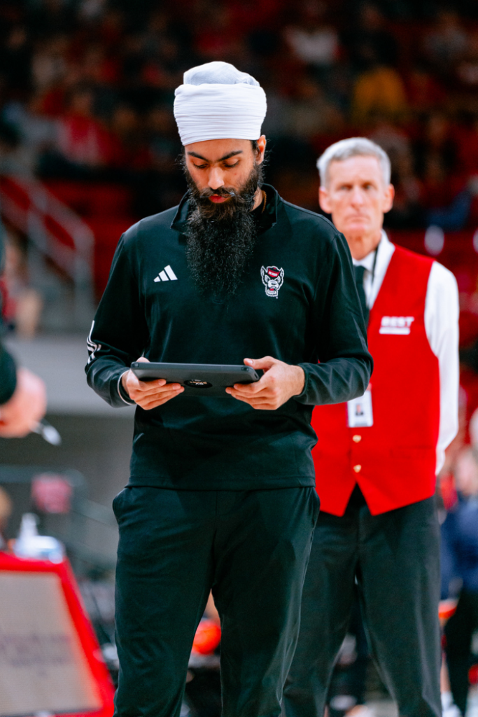 Darasjot Hothi with the coaching staff of NC State women's basketball.